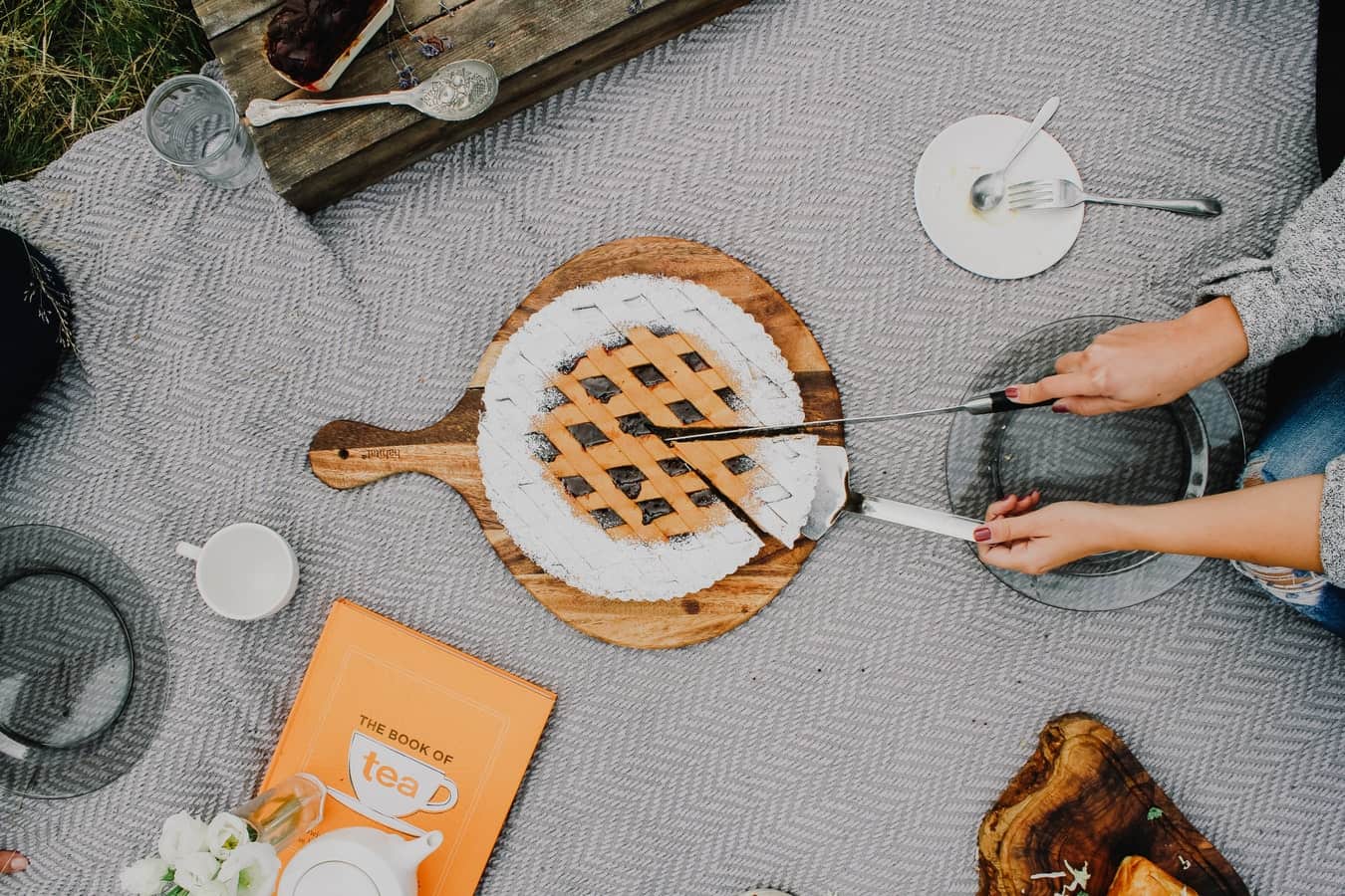 lady slicing cake outdoor