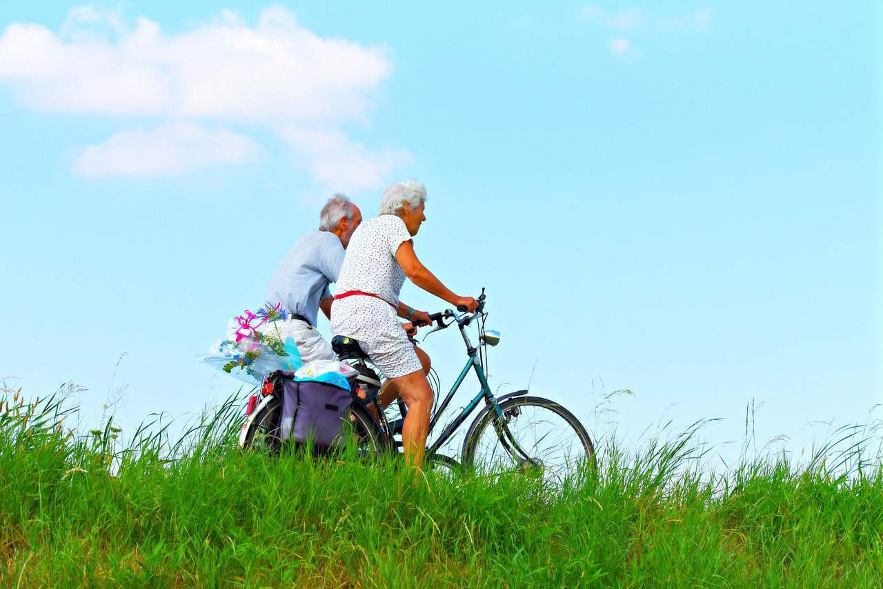 elderly couple biking on their 60th birthday