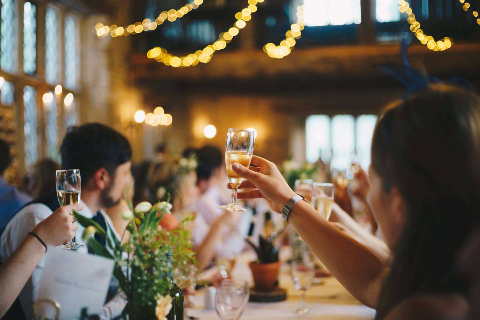 Guests are raising their wine glass for a toast