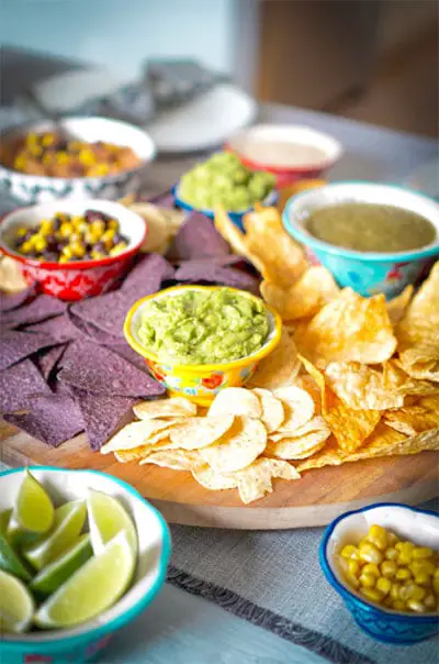 nacho chips beside limes