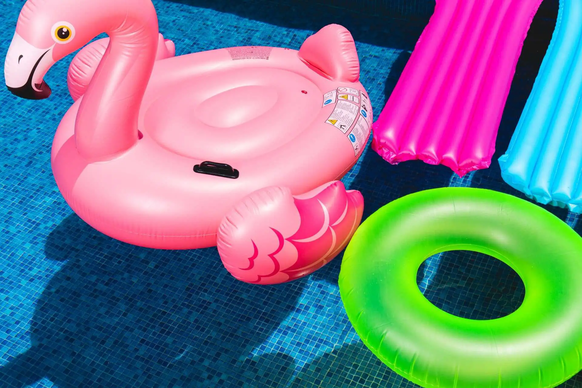 pool party ideas pink inflatable flamingo and green inflatable ring
